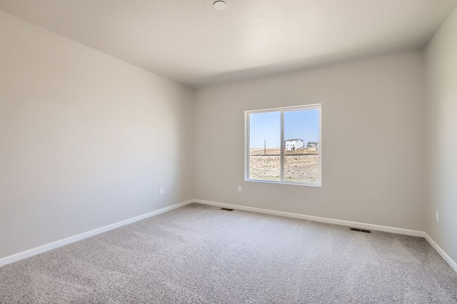 Primary suite with window of the ranch style Telluride plan by Century Communities