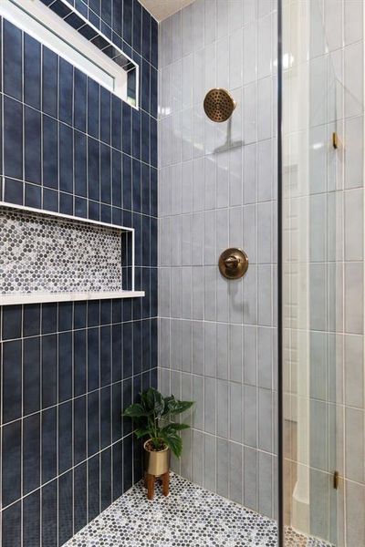 Bathroom featuring tile walls and a tile shower