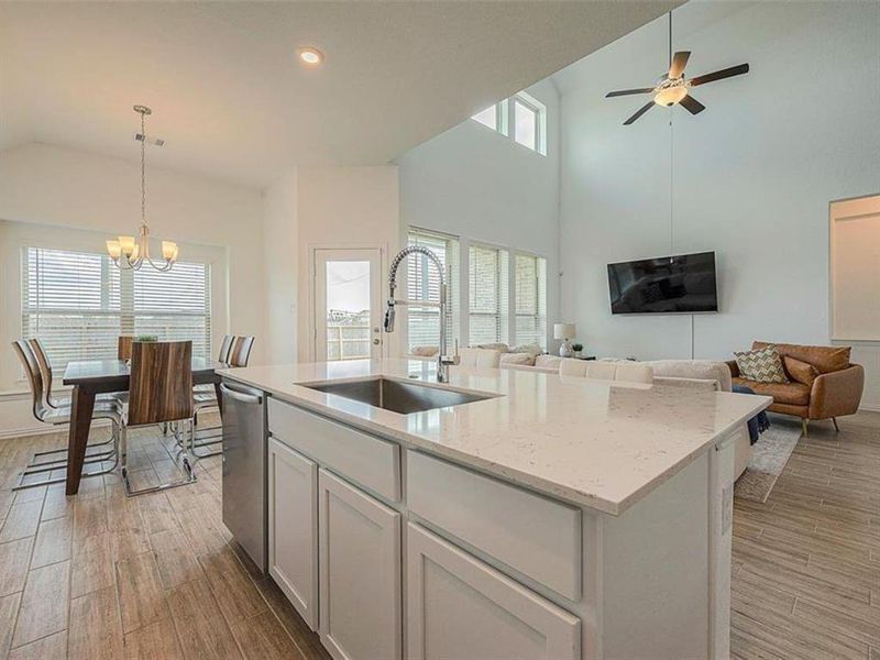 This kitchen features a charming breakfast nook with a table and chairs. It's the perfect spot for enjoying a morning cup of coffee or a quick bite to eat.