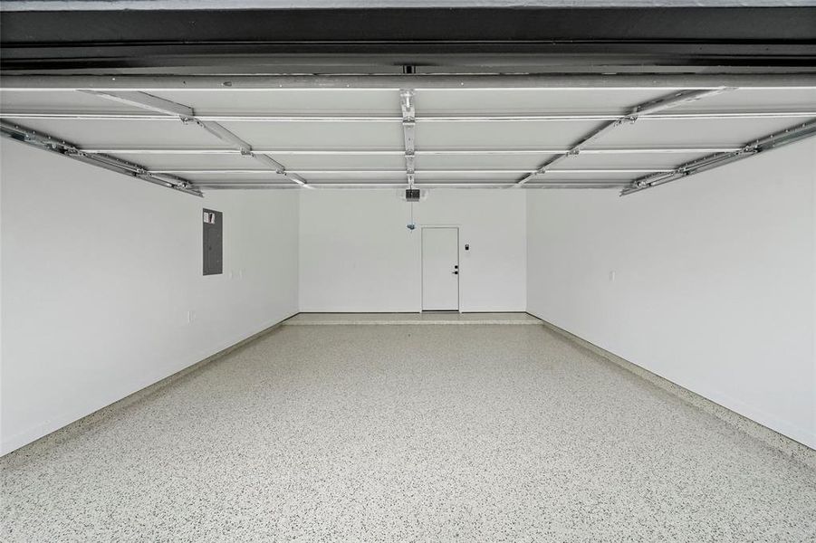 Stunning two-car garage with a durable, high-gloss epoxy floor finish.