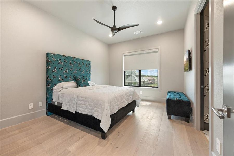 Bedroom featuring hardwood / wood-style floors and ceiling fan