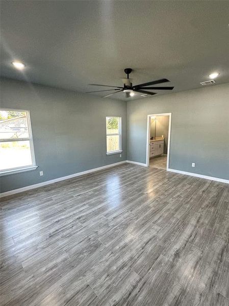 Unfurnished room with a textured ceiling, hardwood / wood-style flooring, and ceiling fan