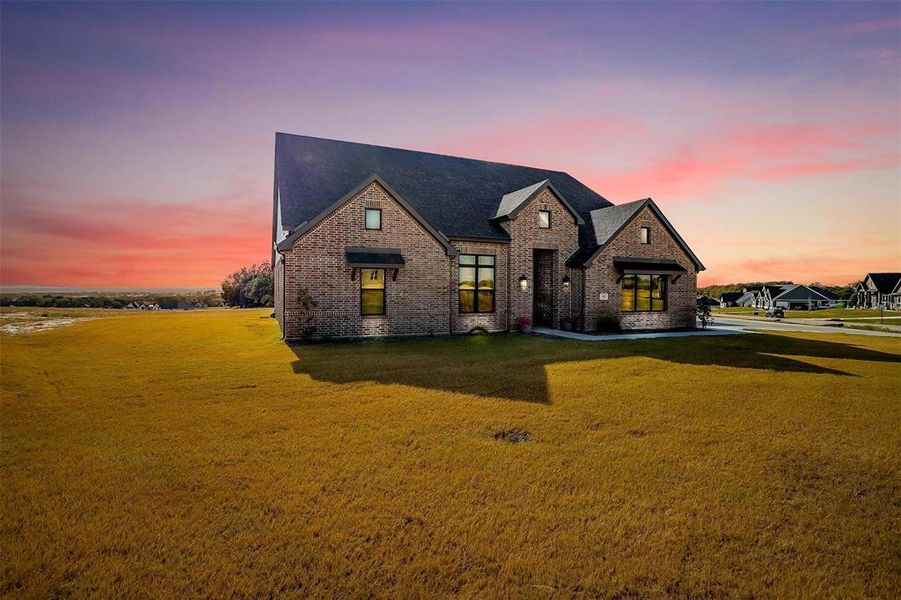 View of front of property featuring a lawn