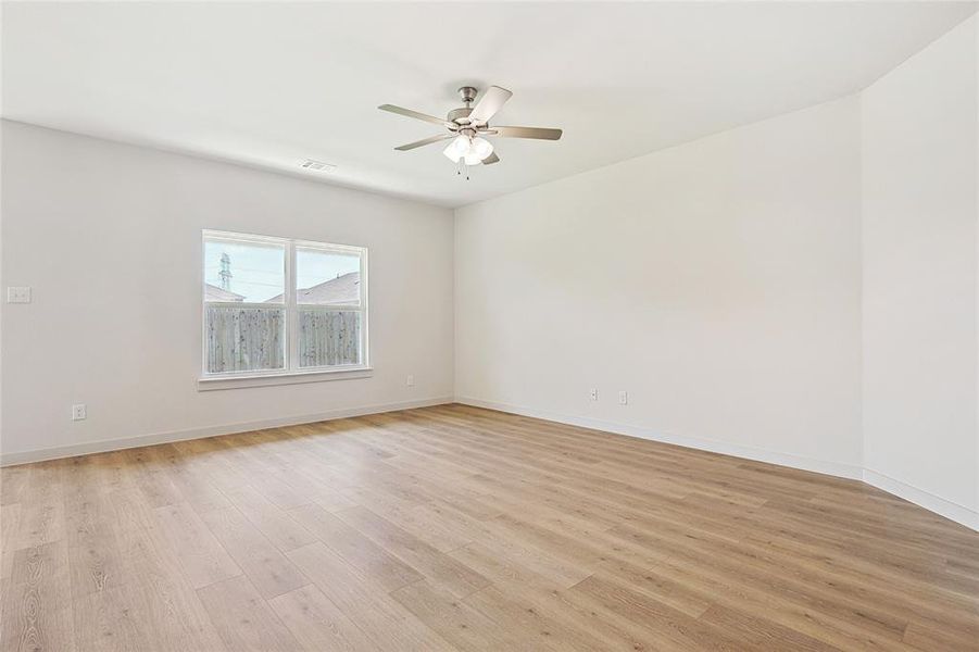 Spare room featuring ceiling fan and light hardwood / wood-style flooring