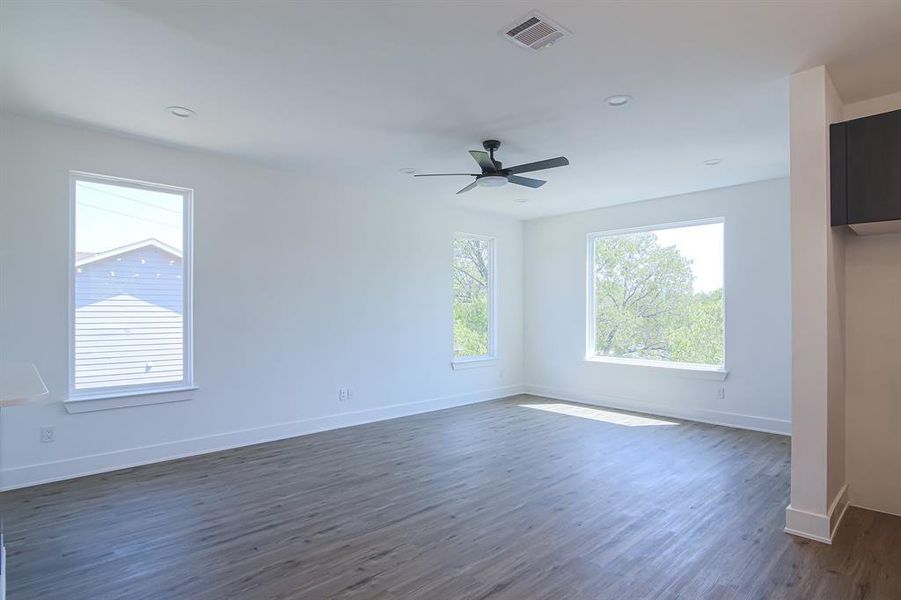 Unfurnished room featuring ceiling fan and dark hardwood / wood-style floors