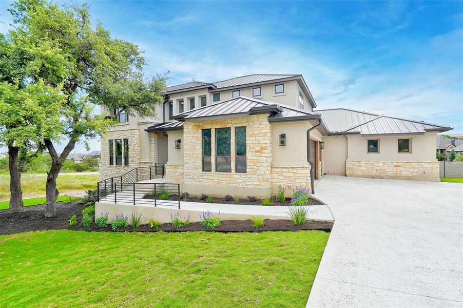 Stunning exterior with large oak trees and extra parking for guests.