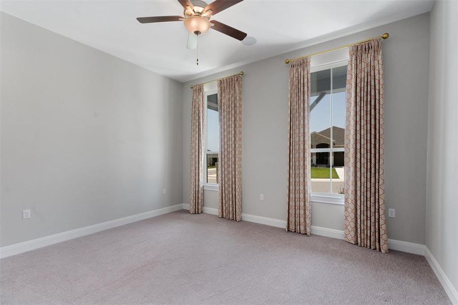 bedroom w/ ceiling fan, walk in closet and private bathroom