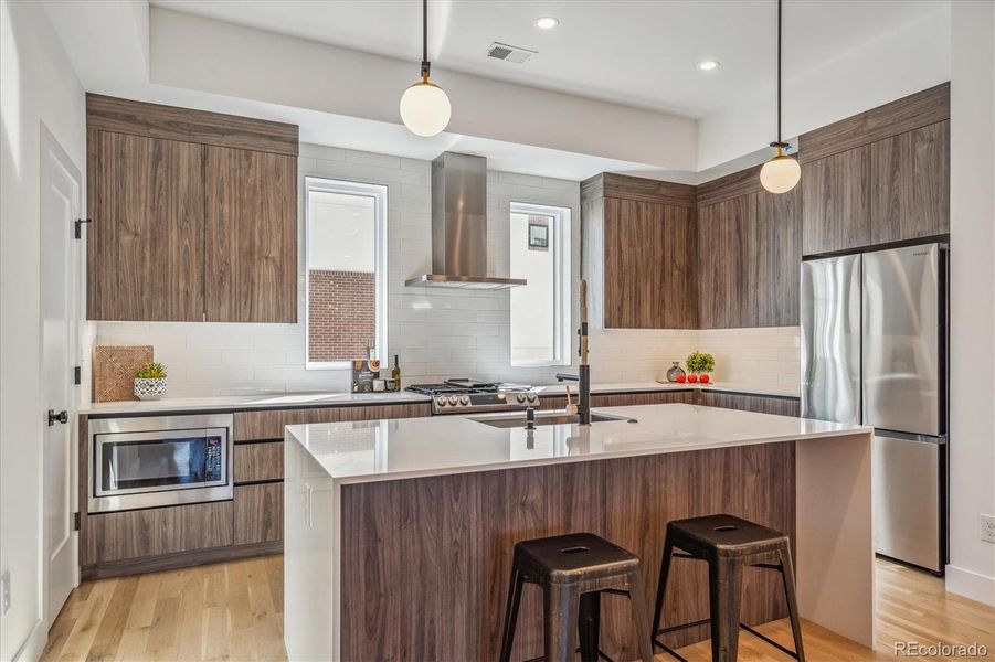 Chef’s Kitchen is the Heart of the Home Complete with Island/Breakfast Bar, Quartz Counters, Designer Lighting, Custom Cabinets, Walk-In Pantry and Stainless Appliances - Gas Range.