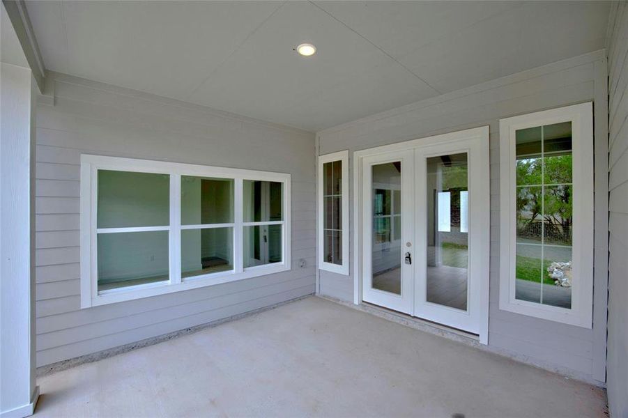 Door enters living room and dining room is through the windows on the left.