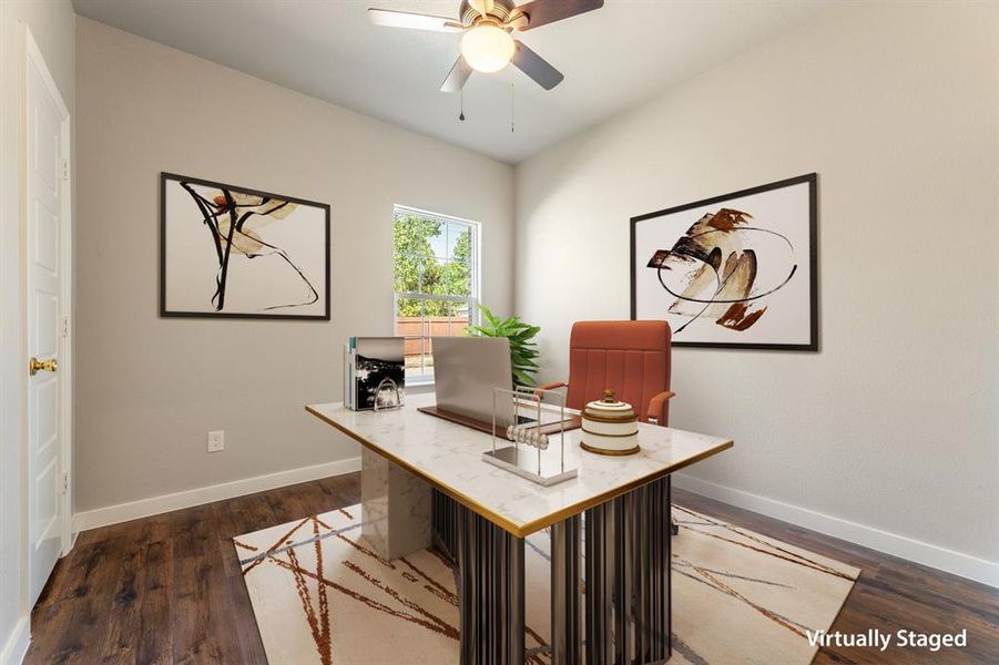 Office area with dark wood-type flooring and ceiling fan