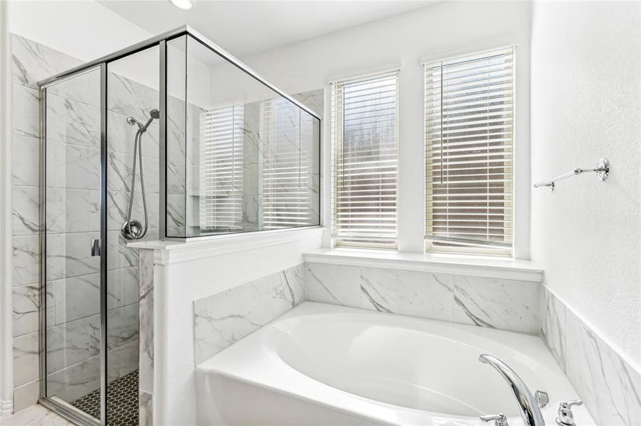 Bathroom featuring shower with separate bathtub