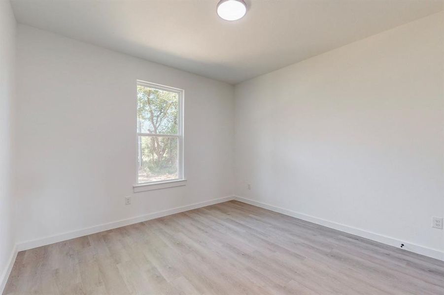 Empty room with light wood-type flooring