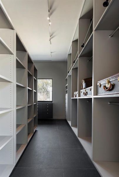 There is plenty of storage for short and long garments, handbags, shoes, accessories, and luggage in the master closet. The packing station is situated by a window, and the natural light improves the packing process.