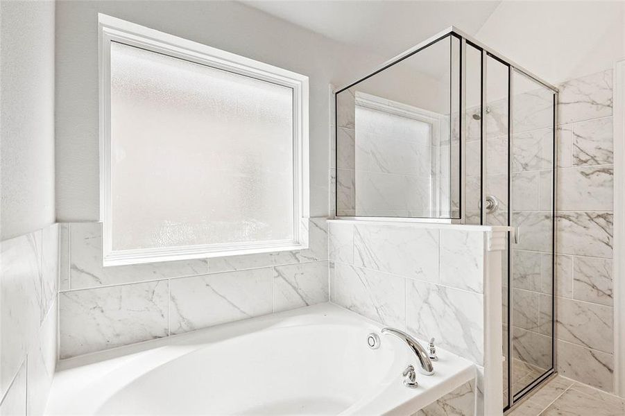 Bathroom featuring tile walls and plus walk in shower