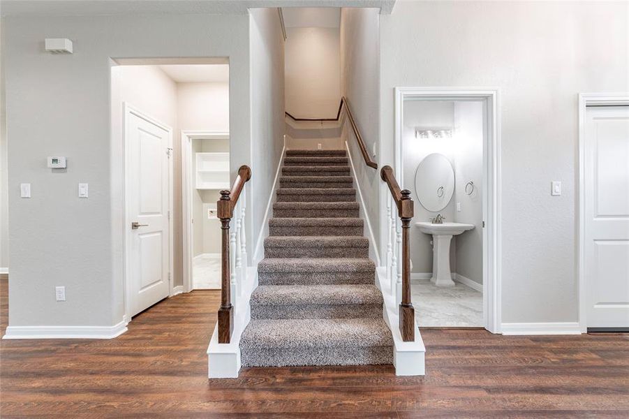 Utility room, stairs, and powder room/half bath