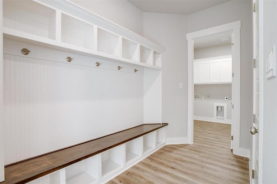 Mudroom with light hardwood / wood-style flooring