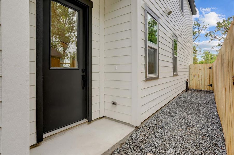 The home has a covered front entry and leaded glass front door.