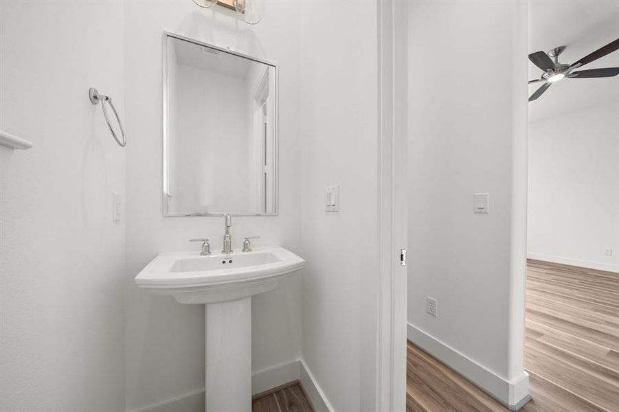 a powder room is located just off the living area and is also next to a study nook