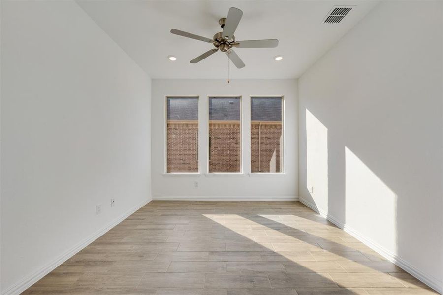 Spare room featuring light hardwood / wood-style flooring and ceiling fan