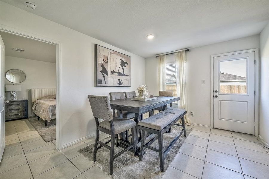 Dining area with light tile patterned floors