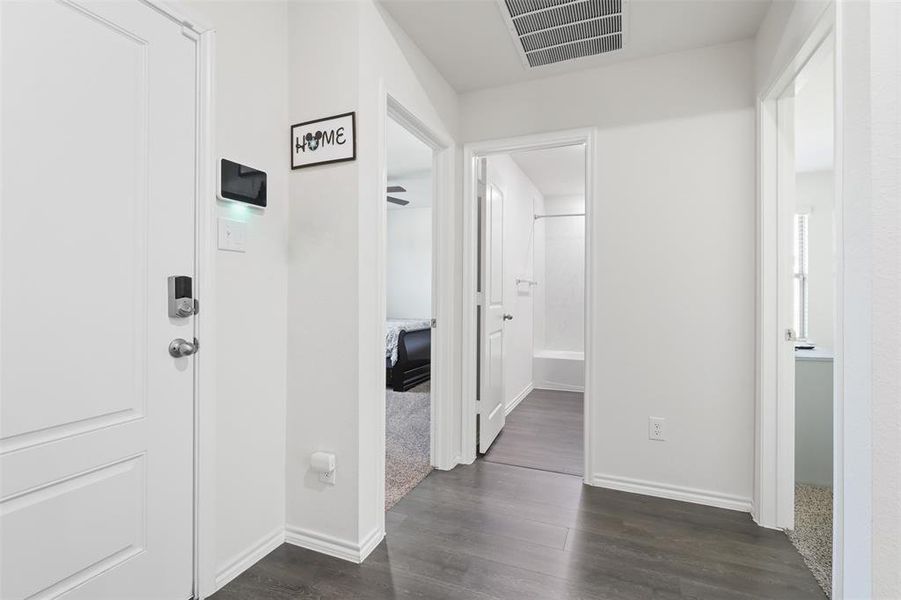 Hallway with dark hardwood / wood-style floors