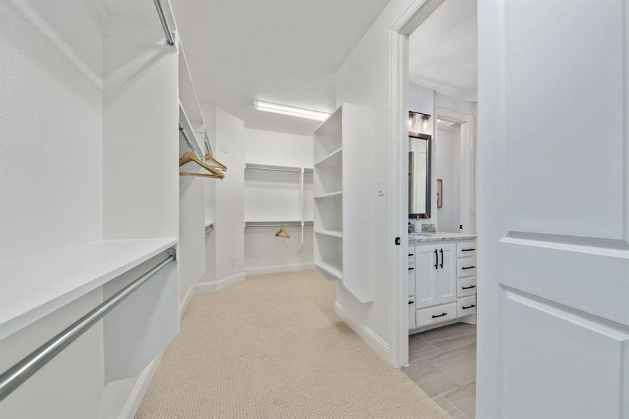 Spacious closet with light colored carpet