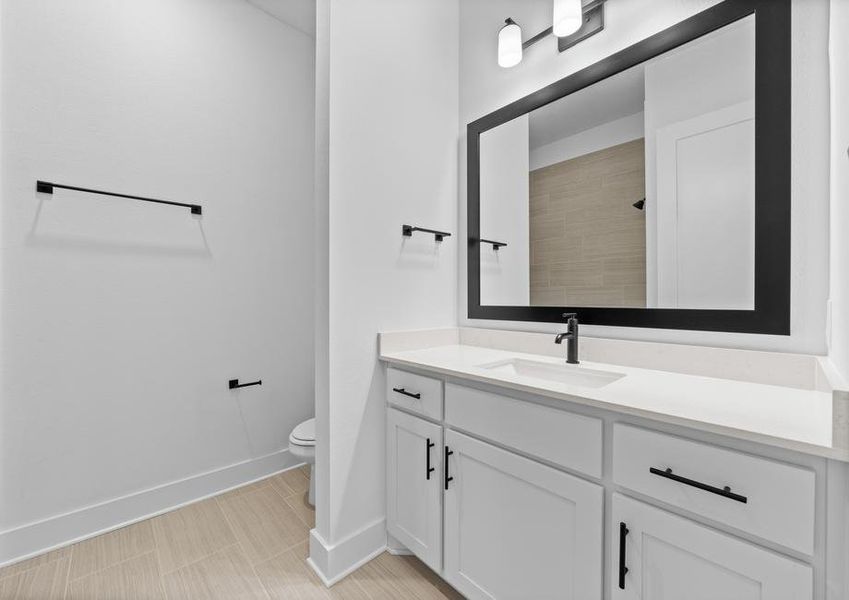 The secondary bathroom has a large vanity with plenty of cabinet space.