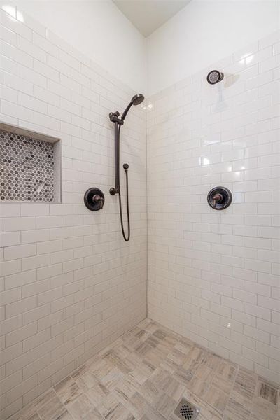 Bathroom featuring a tile shower