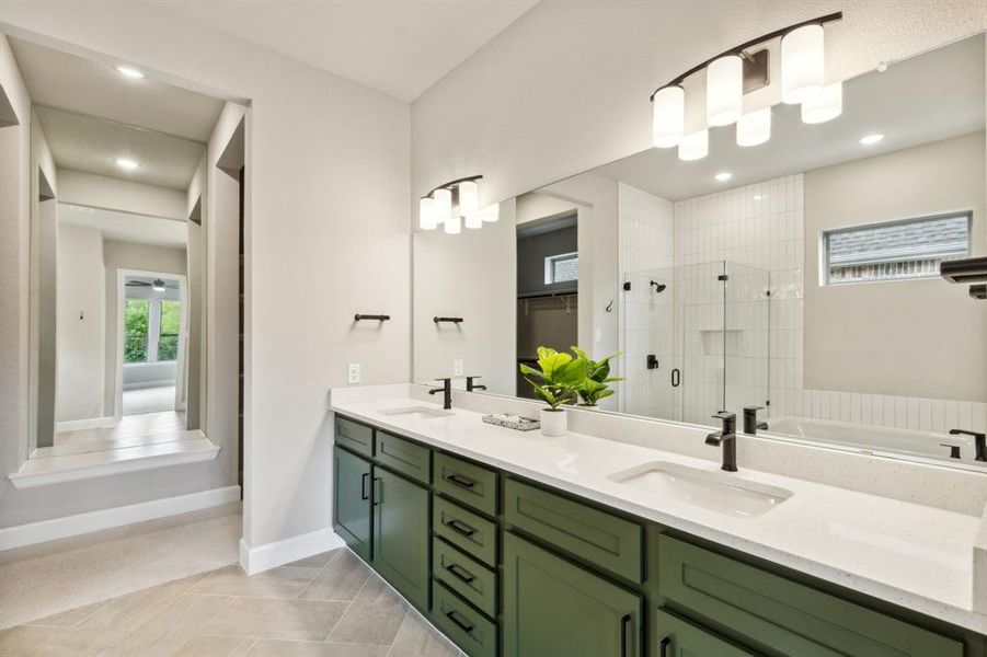 Bathroom with tile patterned floors, shower with separate bathtub, and vanity