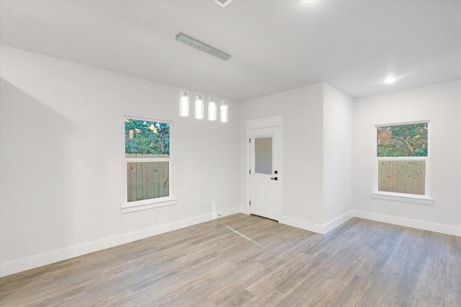 Spare room featuring wood-type flooring