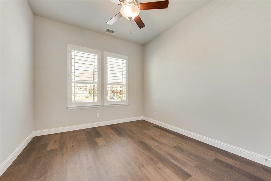 Bedroom featuring ceiling fan and hardwood / wood-style flooring