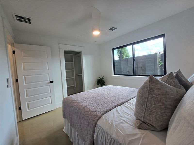 Downstairs bedroom with a view of the closet and it's organizational storage possibilities.