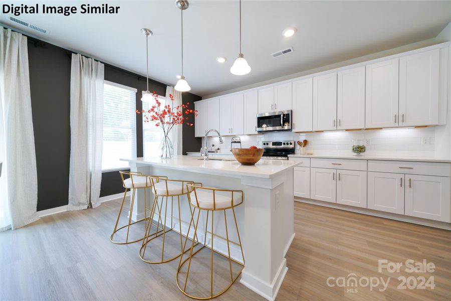 Digital Image Similar: Kitchen features large kitchen island, 42" upper kitchen cabinets, LVP flooring, stainless appliances, and upgraded lighting