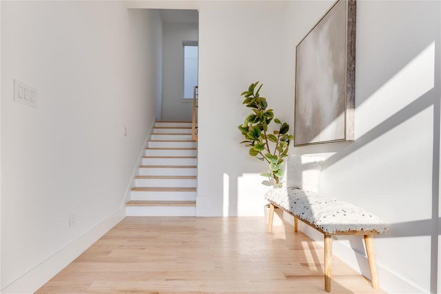 Stairway featuring hardwood / wood-style flooring