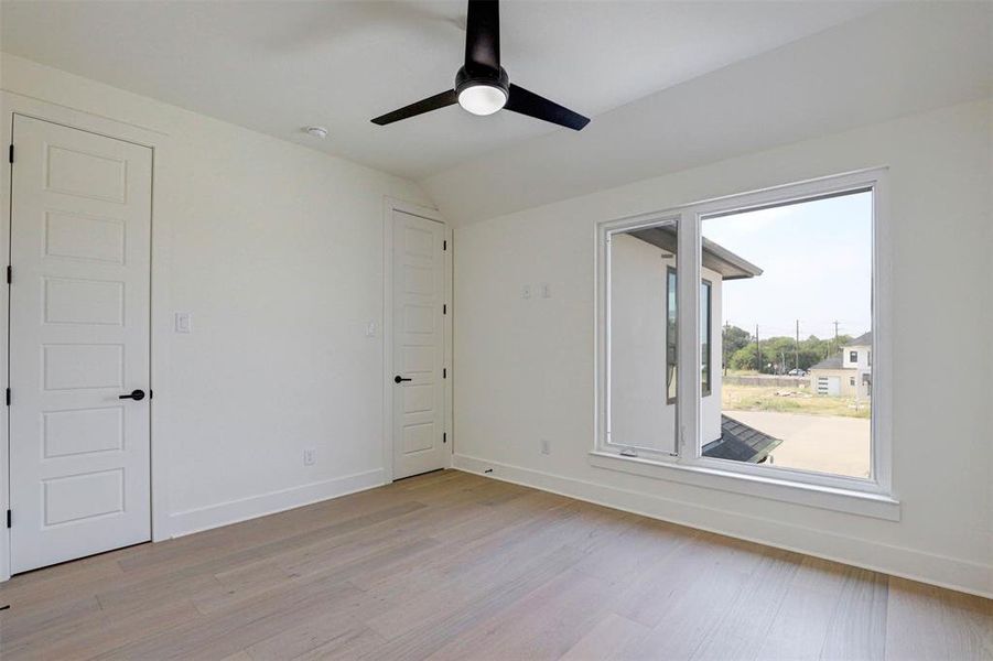 Unfurnished room with light hardwood / wood-style flooring and ceiling fan