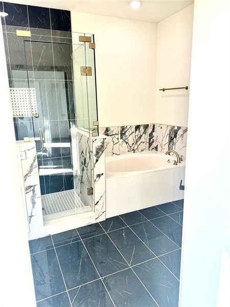 Bathroom with tile walls and plus walk in shower