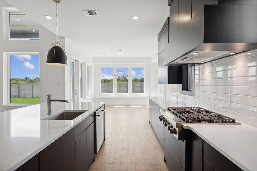 A dream kitchen sporting elegant finishes and a striking color palette is one of the many over the top design elements you will find in this fantastic home!
