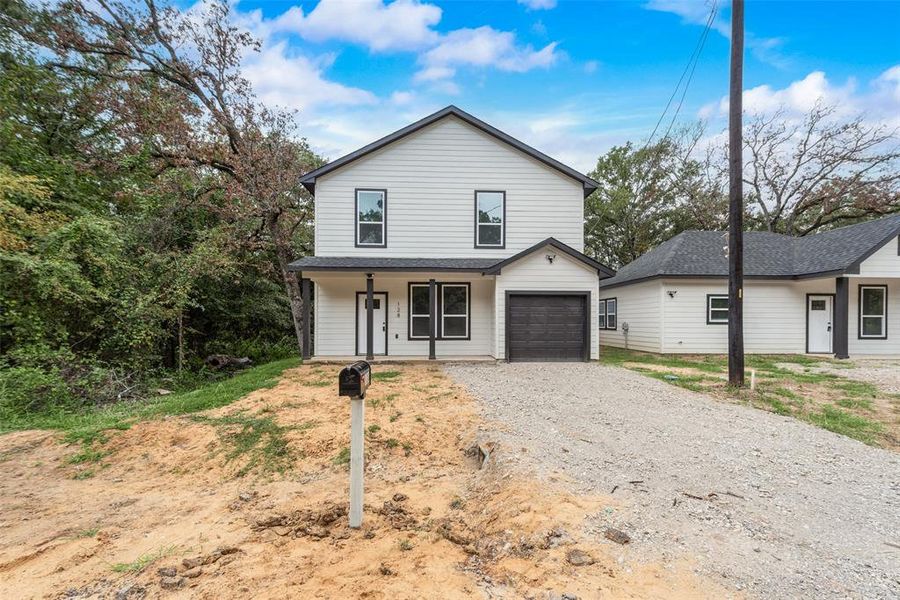 Front of property featuring a garage and covered porch