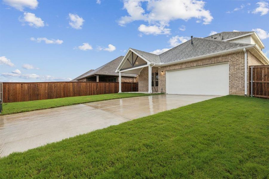 View of front of house with a garage and a front yard