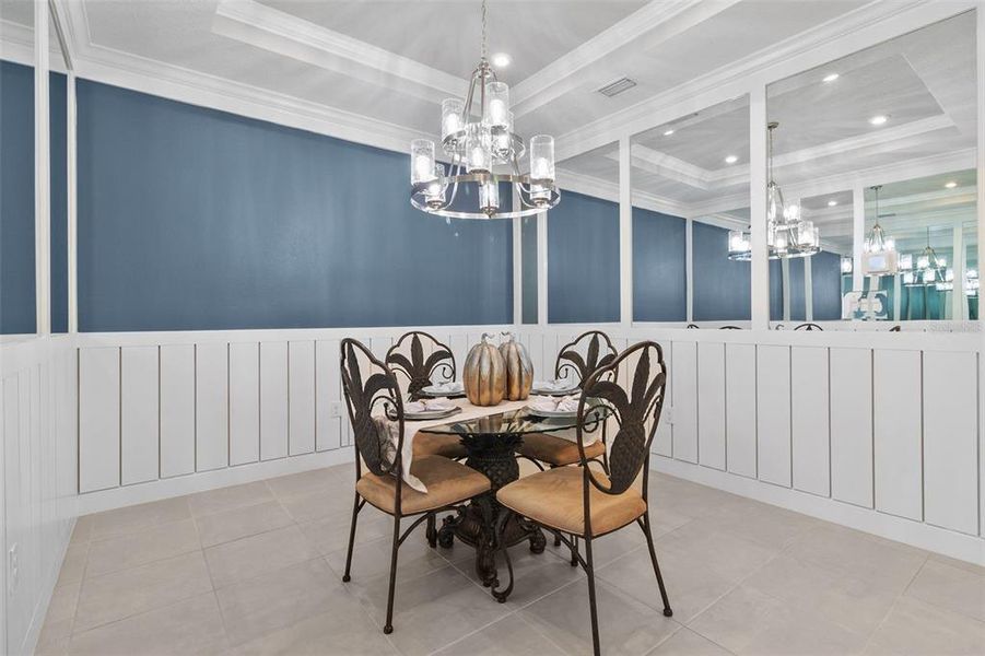 Formal Dining Room with Tray Ceilings and Wainscotting