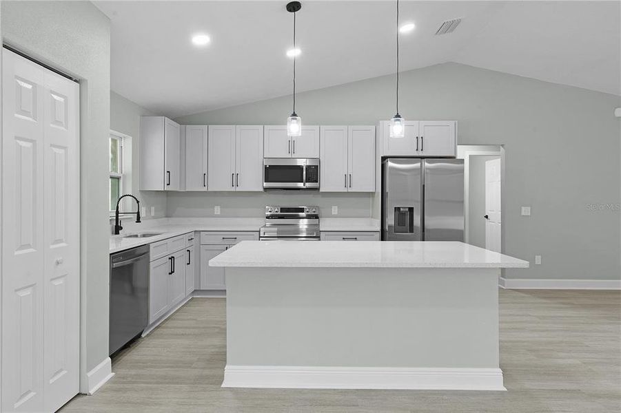 Nice kitchen layout with Samsung appliances and kitchen island with breakfast bar