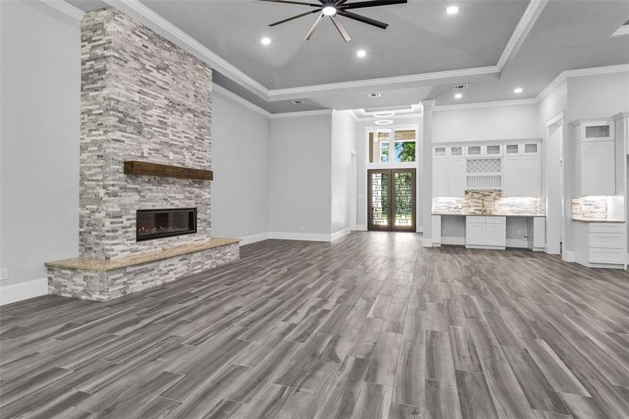 The Family Room offers a wonderful built-in wet bar with space for a small wine refrigerator and a small beverage refrigerator for entertaining and inset stone gas fireplace for entertaining.