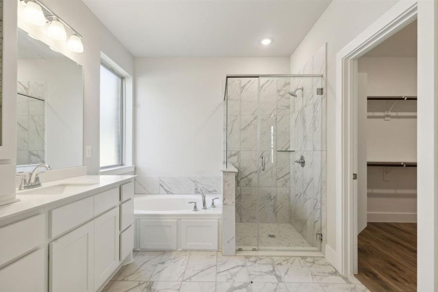 Bathroom with plenty of natural light, separate shower and tub, and vanity