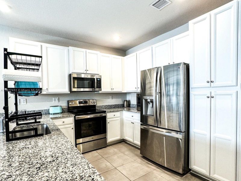 Granite countertops with room for dining. Stainless steel appliances, tall white cabinetry and pantry.See virtual tour to view kitchen and appliances.