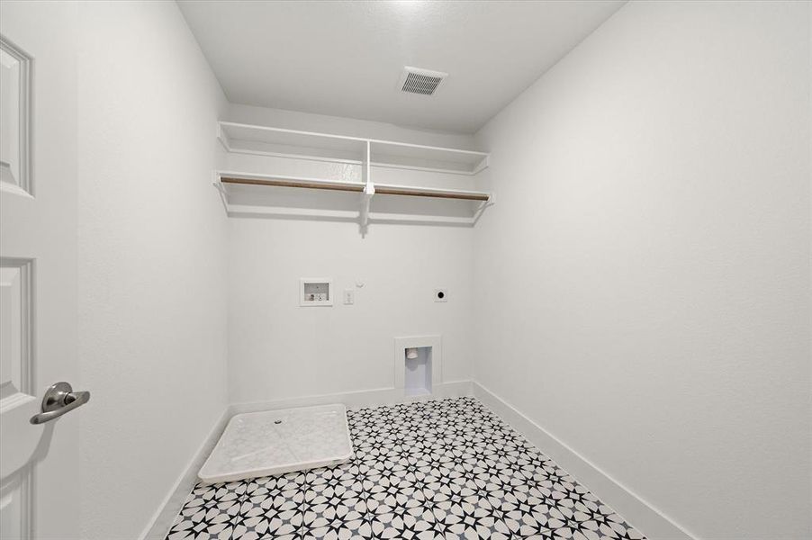 Laundry area featuring hookup for a gas dryer, tile patterned flooring, hookup for an electric dryer, and washer hookup