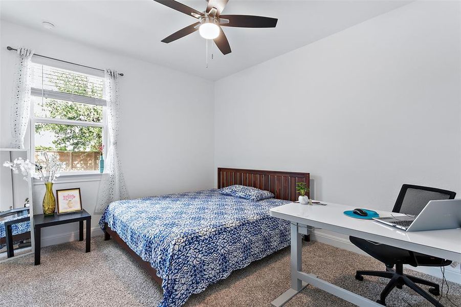 Bedroom 4 has a ceiling fan, walk in closet and is large enough to fit a king size bed and a desk