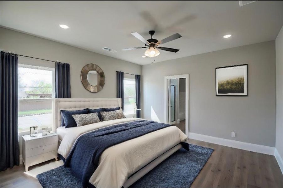 Bedroom featuring connected bathroom, dark hardwood / wood-style floors, and ceiling fan