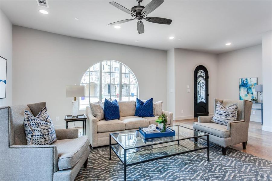 Living room with hardwood / wood-style flooring and ceiling fan