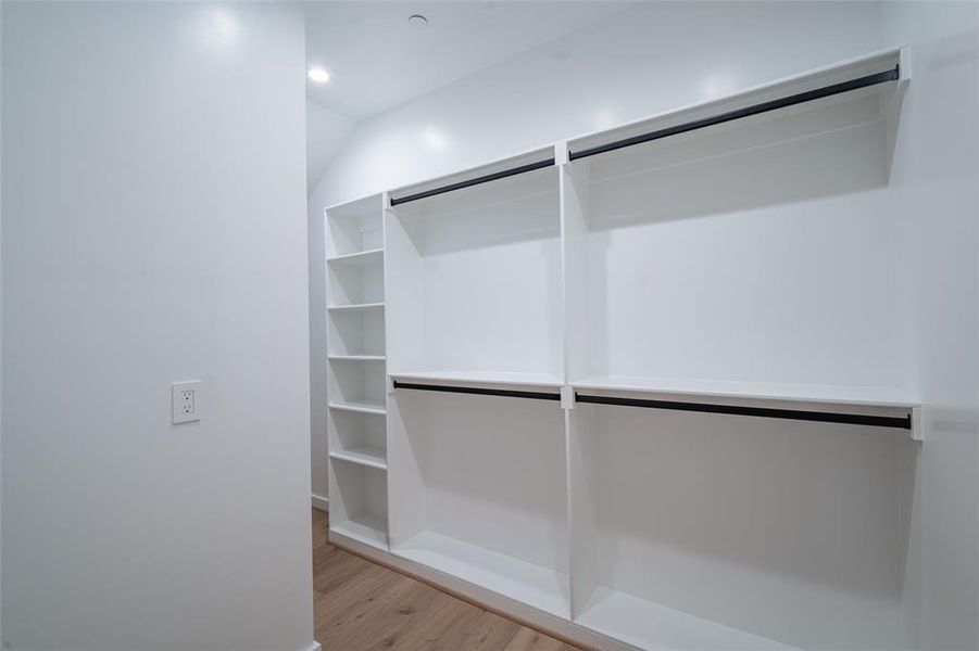 Walk in closet with light wood-type flooring