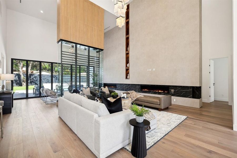 Living area with fireplace, 200+ bottle temp controlled wine vault and imported spanish textured tile